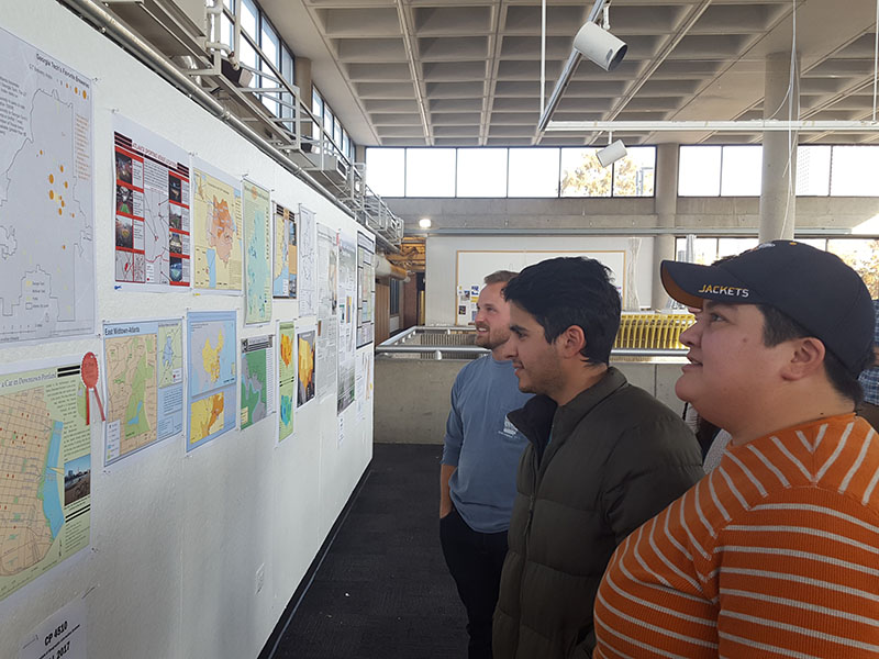 A photo of students looking at their work on display.