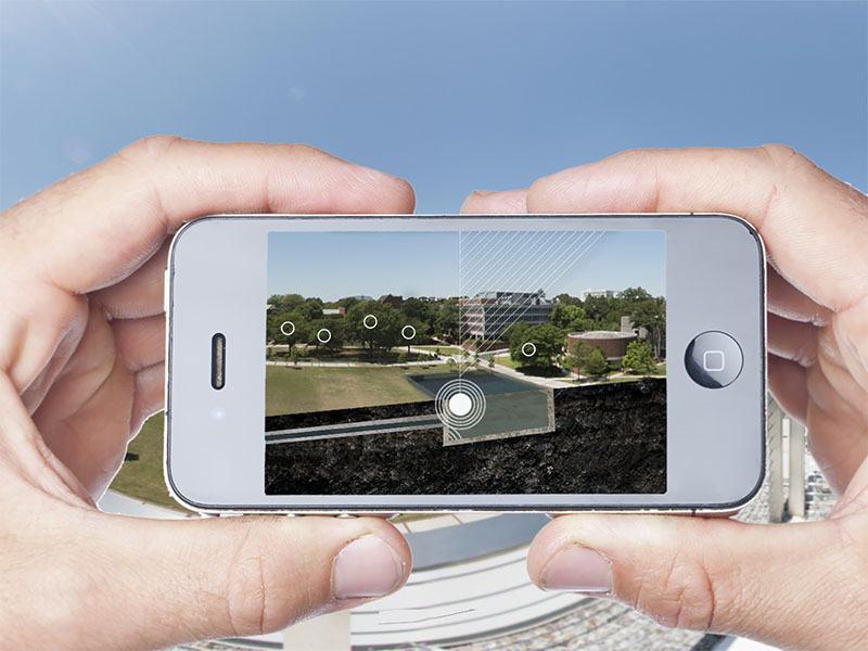 An image of a person holding a smartphone with the arboretum app visible.