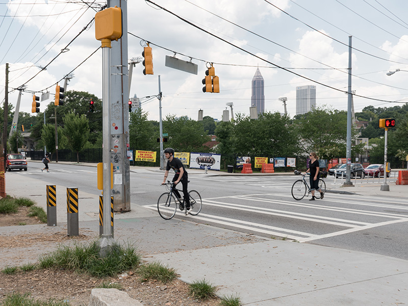 An image of cyclists crossing an urban intersection.