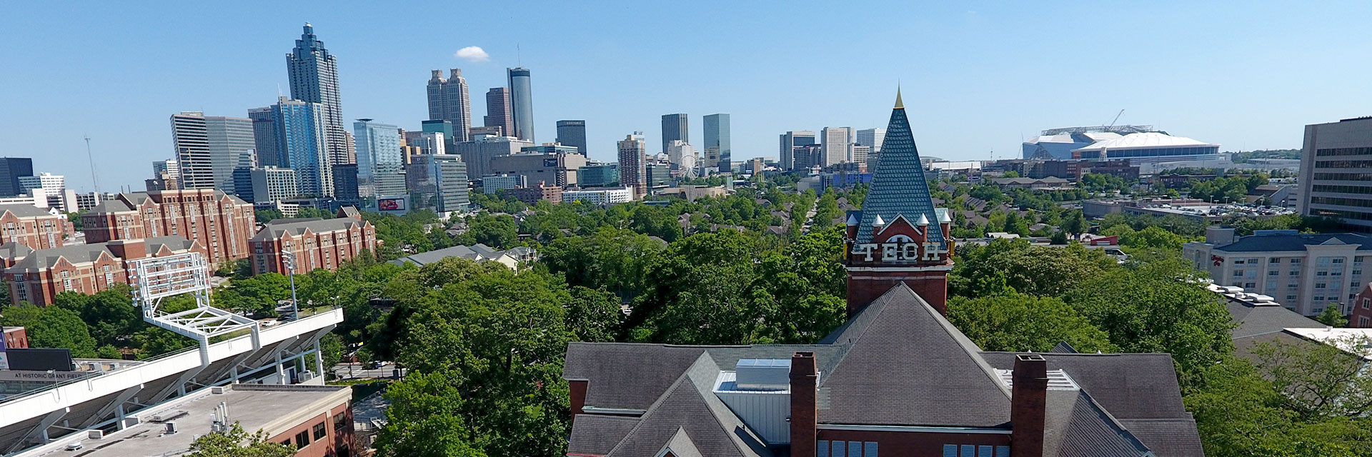 Wide shot of Georgia Tech campus with Atlanta skyline in the background.